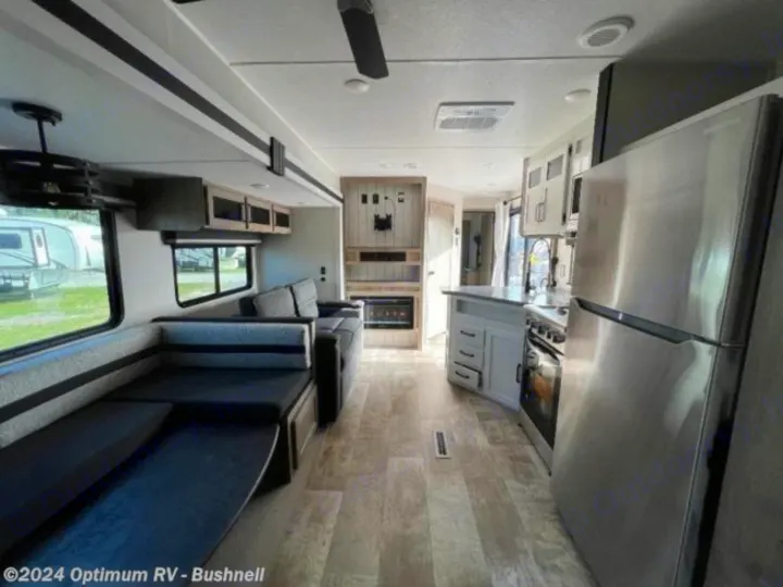 Spacious RV rental interior featuring a large U-shaped dinette, full kitchen, and entertainment center with fireplace.. Forest River Palomino Puma 2022