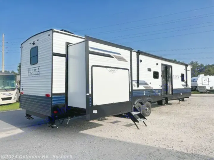 Spacious Puma travel trailer with extended slide-outs, perfect for an RV rental adventure. Steps lead to the main entry.. Forest River Palomino Puma 2022