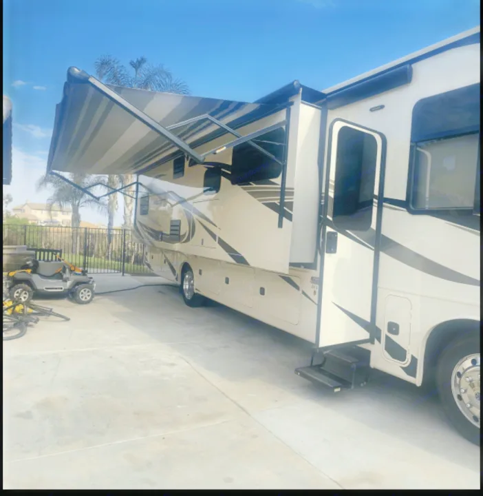 This large RV rental motorhome, with its extended awning and slide-out, is parked on concrete, ready for a comfortable trip.. Jayco Precept 2021