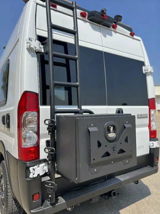 White RV rental rear view: equipped with a sturdy black ladder and a secure storage box for extra cargo.. 27North 27North Class B 2023