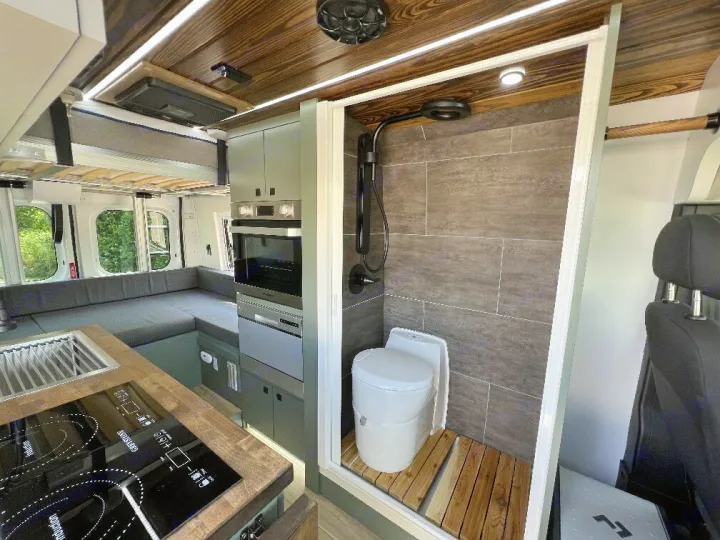 Step inside this custom RV rental. Features include a compact kitchen, comfortable seating, and a cleverly designed wet bath.. 27North 27North Class B 2023