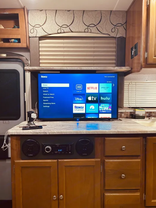 This RV rental's interior features a Roku TV for streaming, Furrion stereo system, and a compact counter with a sink area.. COACHMEN LEPRECHAUN 2019
