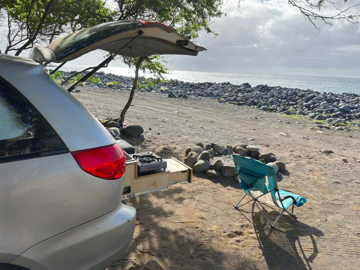 Beach camping with a minivan's custom pull-out kitchen. Experience this freedom with an RV rental!. Toyota Other 2006