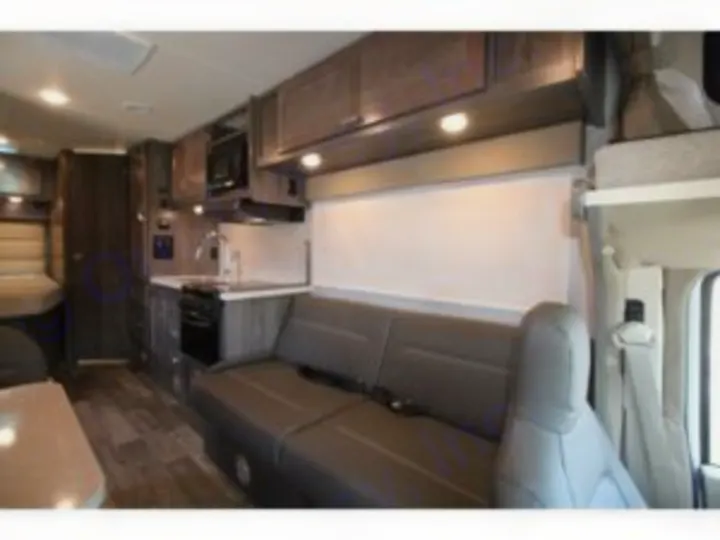 Inside a modern RV rental: a well-equipped kitchen, comfortable sofa, and overhead storage, perfect for your next adventure.. Winnebago Minnie Winnie 2024
