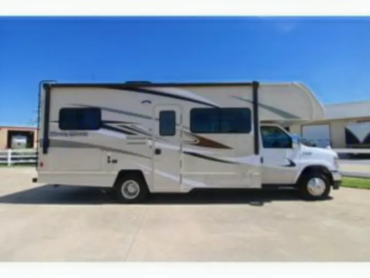 A spacious Class C RV rental, perfect for family road trips and camping adventures, is parked outdoors.. Winnebago Minnie Winnie 2024