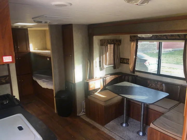 RV rental interior: kitchen, bunk beds, and a cozy dinette with window views. Ideal for travel.. Keystone RV Bullet Ultra Lite 2015