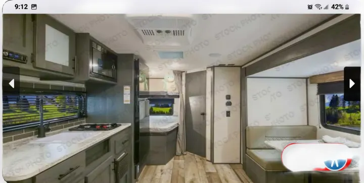 Spacious RV rental interior featuring a modern kitchen, bunk beds, and a comfortable dinette.. Forest River ASPEN TRAIL 2024
