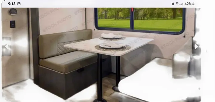 Explore a compact RV rental dinette with comfortable booth seating and a table, ideal for meals on the road.. Forest River ASPEN TRAIL 2024