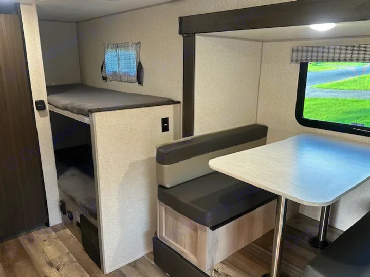 RV rental interior featuring cozy bunk beds & comfortable dinette. Ideal for family road trips.. KZ Classic 2022