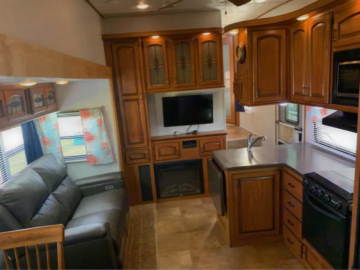 Spacious RV rental interior with full kitchen, living area, comfy sofa, and TV for your next adventure.. Forest River Palomino Sabre 2015