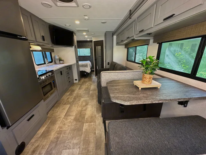 Spacious RV rental interior featuring a full kitchen, dinette, and cozy living area, ideal for travel.. Forest River Solera 2021