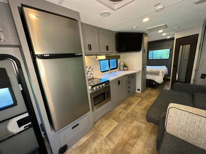 Modern RV rental interior featuring a well-equipped kitchen, comfy living area, and cozy bedroom.. Forest River Solera 2021