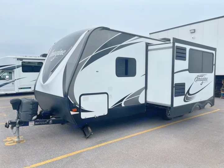White and black Imagine travel trailer with extended slide-out, ideal for your next rv rental adventure.. Grand Design Other 2018