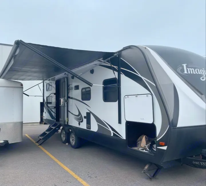 RV rental: Modern white & black travel trailer with extended awning, steps deployed, and storage open.. Grand Design Other 2018