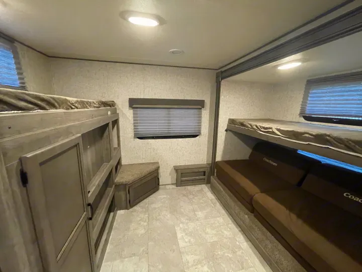 RV rental bunkhouse with two sets of bunks, sofa, window, and storage. Ideal for family travel.. Coachmen Apex 2019