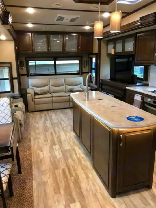 Spacious RV rental interior featuring a modern living area, kitchen island, and cozy sofa, perfect for your next adventure.. Grand Design Solitude 2019