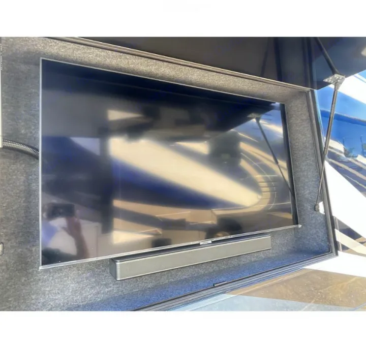 RV rental features a large outdoor TV and soundbar, housed in a carpeted compartment for mobile entertainment.. Newmar Ventana 2023