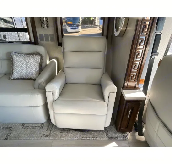 RV rental interior: luxurious white leather seating, including a sofa and recliner, offers comfort for your travels.. Newmar Ventana 2023