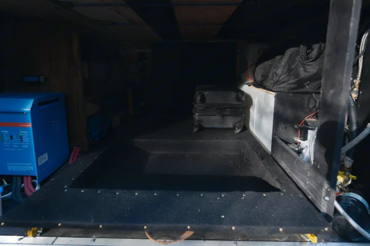 RV rental's utility compartment features a blue inverter, water pump, and organized storage for your travels.. Mercedes-Benz Sprinter 2021