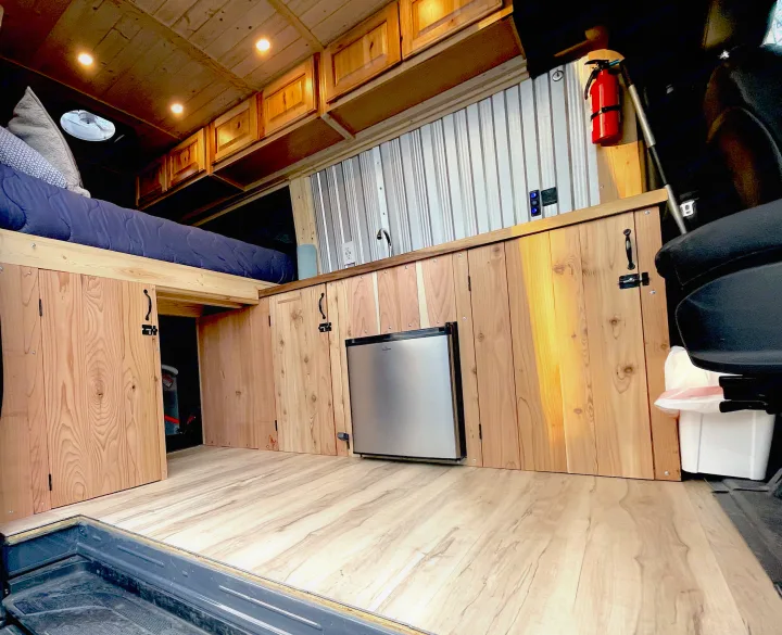 Experience this custom van conversion RV rental! Features a raised bed, compact kitchen, and smart storage solutions.. Mercedes Sprinter 2017