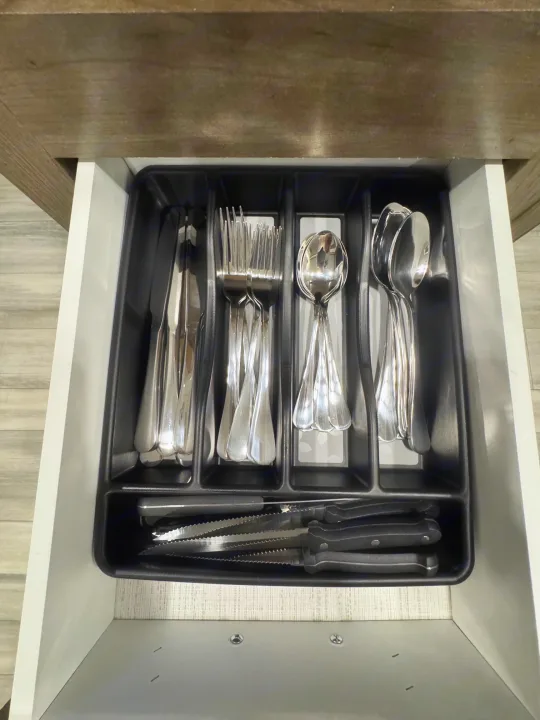 RV rental kitchen drawer with organized silverware: knives, forks, spoons & steak knives. Ready for your trip!. Heartland RVs Pioneer 2021