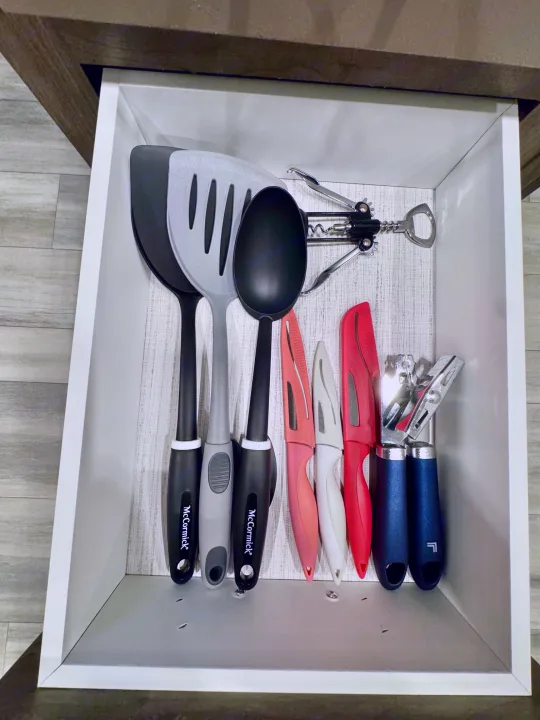 An organized RV rental kitchen drawer with cooking utensils, knives, a bottle opener, and can openers.. Heartland RVs Pioneer 2021