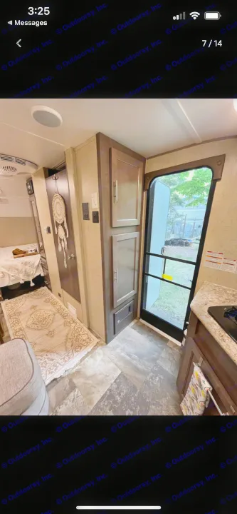 Explore the cozy interior of this RV rental, featuring a compact kitchen, sleeping area, and entrance door.. R-Pod Hood River Edition 2016