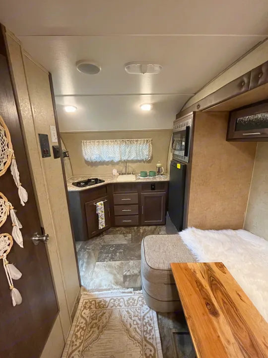 Cozy RV rental interior with a fully equipped kitchen and comfortable seating area, perfect for travel.. R-Pod Hood River Edition 2016