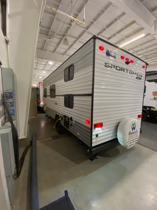 This Sportsmen Classic travel trailer, seen indoors, could be an excellent RV rental option from Minard's Leisure World.. KZ Sportsmen Classic 180BH 2024