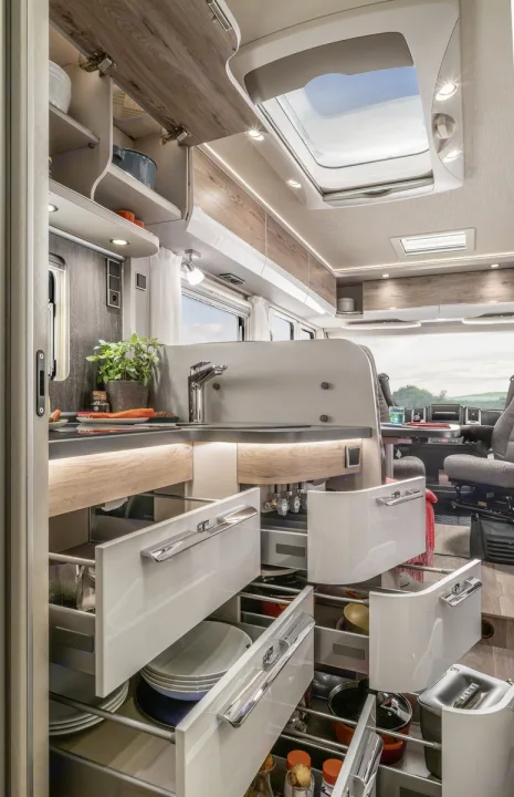 This modern RV rental features a full kitchen with open drawers & cabinets, showcasing smart, ample storage.. Hymer Exis I 678 2024
