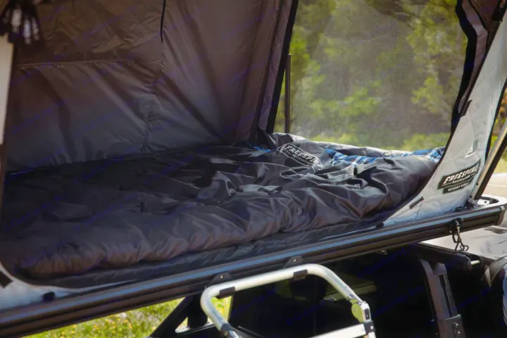 Spacious roof-top tent interior on a vehicle, with bedding & mesh windows, ideal for camping adventures or an RV rental.. Toyota Tacoma TRD OFF ROAD 2018