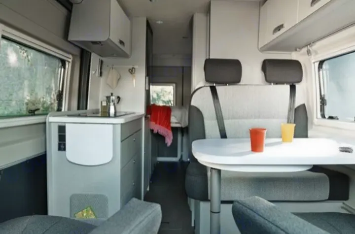 Modern rv rental interior with compact kitchen, dining area, and comfortable seating for mobile living.. Hymer FREE 600 CAMPUS 2024