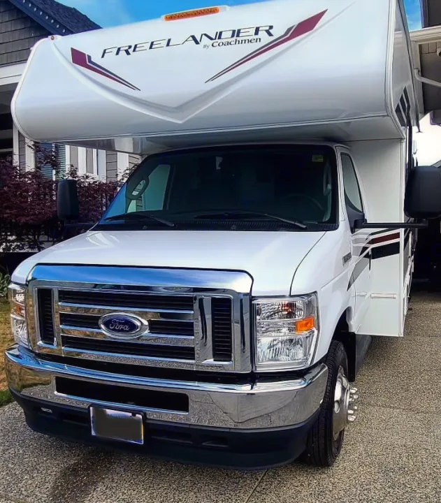 Front view of a clean white Ford Coachmen Freelander Class C RV parked. Perfect for your next RV rental adventure.. Freelander Coachman 2023