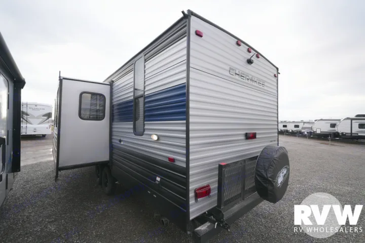 This Cherokee RV travel trailer, with its slide-out open and spare tire mounted, is ready for your next RV rental adventure.. Forest River Patriot 26DBH 2022