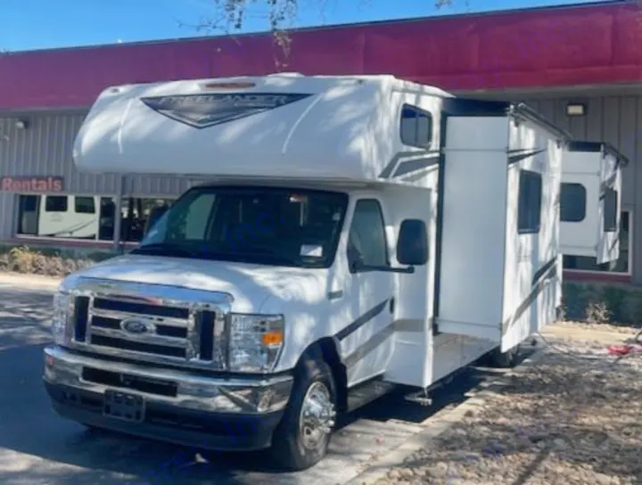Front view of a white Class C Ford Freelander RV rental with slide-outs extended, parked on pavement.. Coachmen FREELANDER 2025
