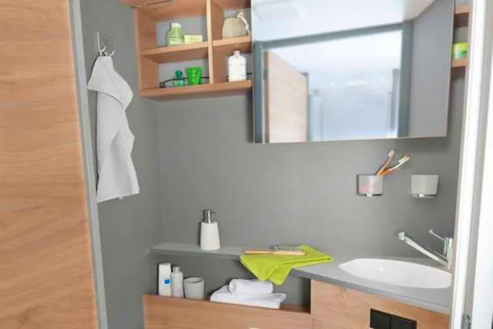 Discover the well-appointed bathroom in this RV rental, complete with a sink, mirror, and ample storage for your journey.. Dethleffs Just T7052 DBM 2024