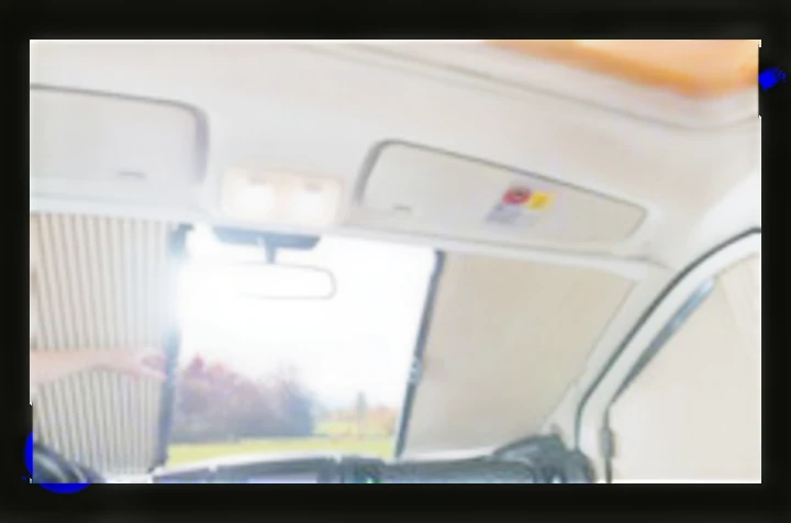 RV rental interior: Sunshades on windshield and side windows for privacy and comfort. A hand adjusts a blind.. Dethleffs Just T7052 DBM 2024