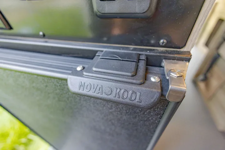 Close-up of a sturdy Nova Kool RV refrigerator latch with embossed branding, ready for your rv rental adventure.. Winnebago Solis Pocket 2022