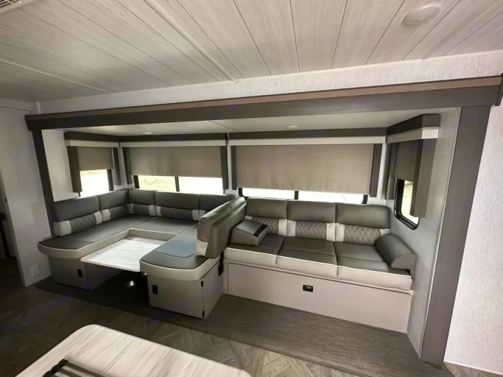 RV rental's spacious grey lounge & dinette area, featuring a pull-out table. Modern, comfy travel awaits!. Forest River Salem Platinum 2024