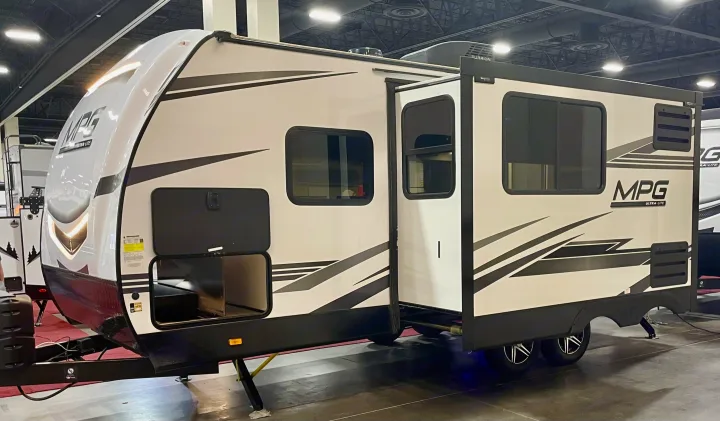 White MPG Ultra-Lite travel trailer RV, ideal for an rv rental, with extended slide-out and storage features visible.. Cruiser RV MPG Ultra Lite 2022