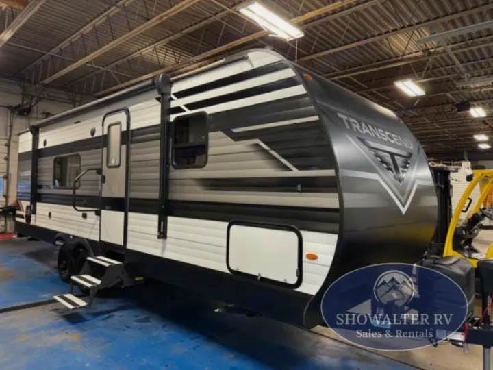 This sleek Transcend travel trailer RV, in grey and white, is shown indoors, ready for your next rv rental adventure.. Grand Design Transcend Xplor 2022
