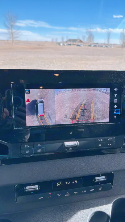 Inside an RV rental, the dashboard screen displays a 360-degree camera view, along with climate and media controls.. Mercedes-Benz Sprinter High Roof Medium wheelbase 2021