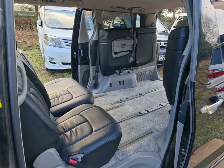 Flexible seating in a spacious minivan, showing black seats & floor rails. Great for a comfortable rv rental experience.. Toyota Alphard 2024