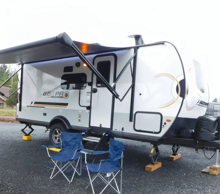 This Geo Pro rv rental is set up for a comfortable outdoor experience with its extended awning and camping chairs.. Forest River GeoPro 20BHS 2022