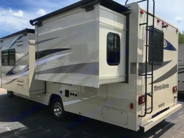 Explore in comfort! This light-colored Minnie Winnie RV rental, parked with slide-outs open, offers ample space.. Winnebago Minnie Winnie 2024