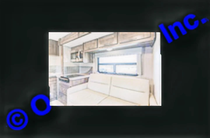 RV rental interior featuring a well-equipped kitchen, comfortable sofa, and large window, ideal for travel adventures.. Nexus RV Triumph 2022