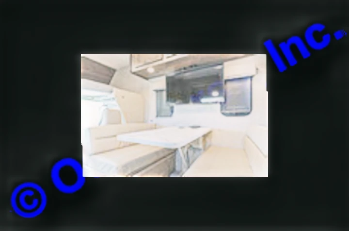 Comfortable RV rental interior: a spacious U-shaped dinette with cushioned seating, table, and wall-mounted TV, perfect for dining.. Nexus RV Triumph 2022