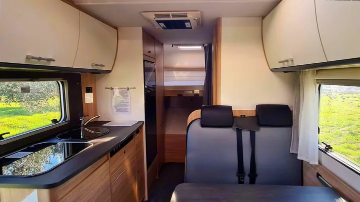 Modern rv rental interior with a functional kitchen, dining area, and rear bunk beds for your next adventure.. Sunlight A68 2024