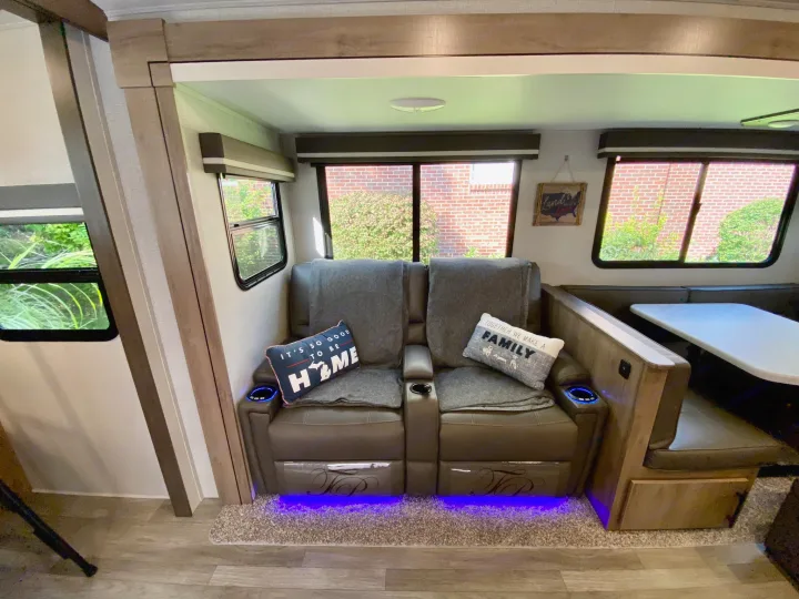 This RV rental offers a cozy interior with power recliners, under-lighting, and a dinette for dining or lounging.. Grand Design Imagine 2023