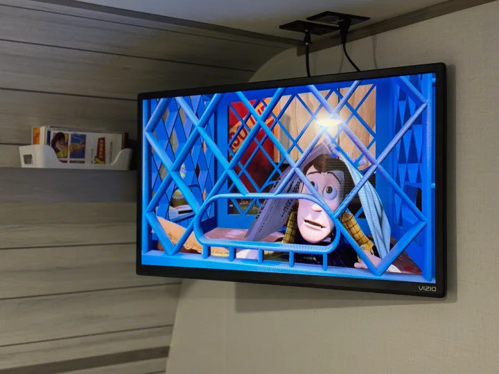 RV rental interior: A VIZIO TV plays Toy Story, showing Woody trapped behind blue bars.. Coleman Lantern LT 17B 2024